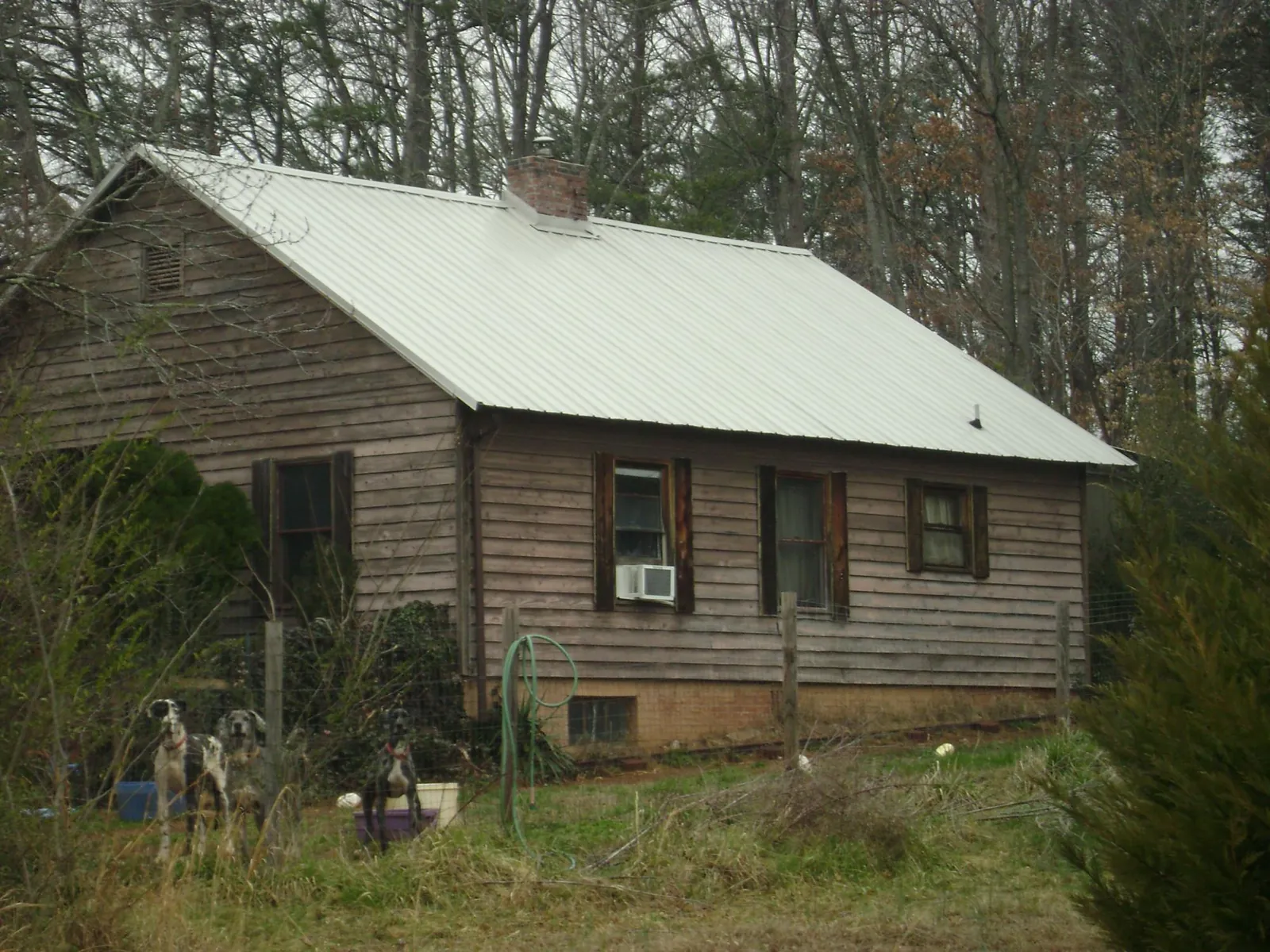 White metal roof on an old wood sided farmhouse, from a Metal Roof Installation job in Claremont
